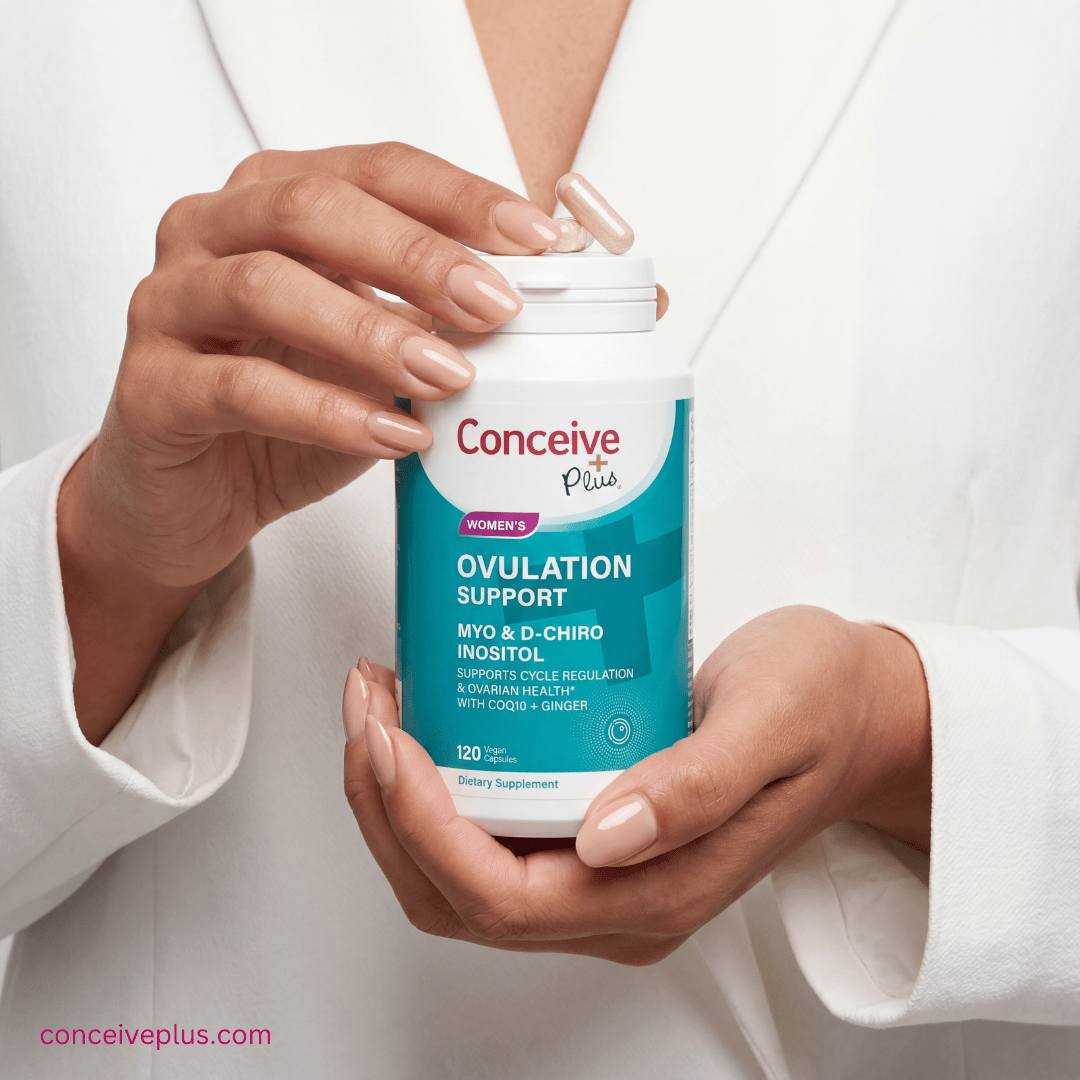 Person holding a container of Conceive Plus ovulation support supplement.